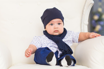 Adorable baby boy in sunny bedroom. Newborn child relaxing