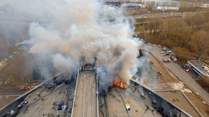 Aerial view of the major fire on the roof of a building. Extinguishing fire firefighters.