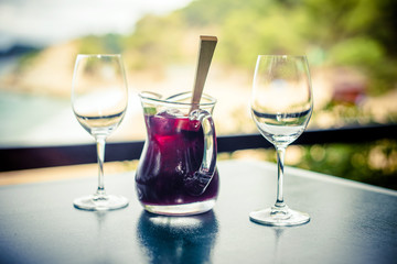 Jug with Sangriya and two glasses on the table 
