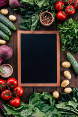 chalk board on a wooden background surrounded by vegetables, food frame, menu design, vegetables on...