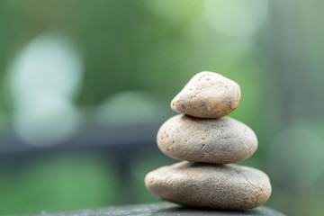 Nature Concept. Close up of stack of stone on wooden table for background or wallpaper