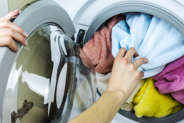 Woman gets clothes from the washing machine