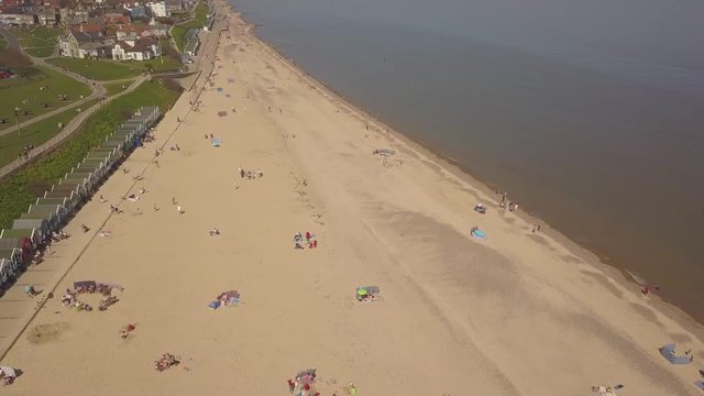 People enjoy the beach on a sunny day Aerial drone shot 