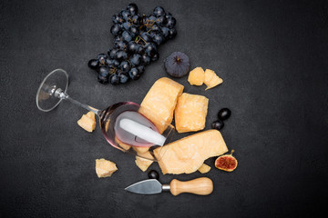 pieces of parmesan or parmigiano cheese, wine and grapes