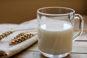 a glass of fresh milk on the wooden table