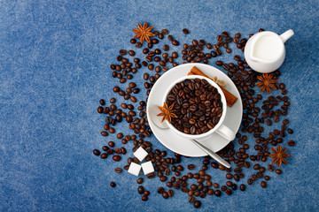Cup of coffee milk sugar spoon cinnamon anis