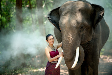 Asian woman enjoying with elephant at Chang Village Surin province Thailand.