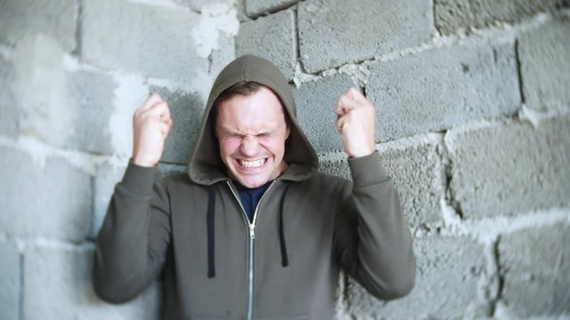 desperate unhappy man by the wall. 4k, the concept of stress and hopeless