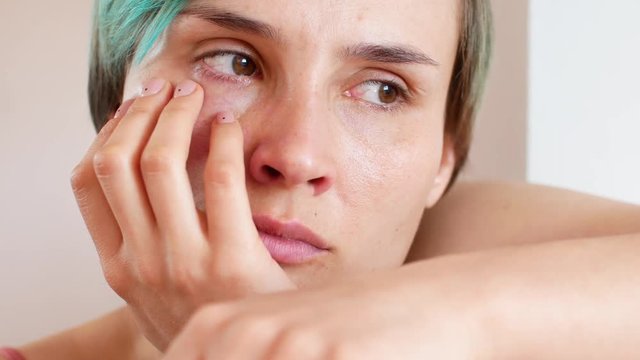Woman crying at home, close-up of face and emotions