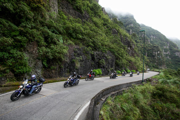 Speedy motorcycles on road in the mountains with beautiful landscape