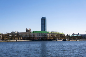 Fototapeta premium Yekaterinburg, Russia - May 02, 2018: city landscape and view of the Vysotsky tower from the waterfront of the City pond..