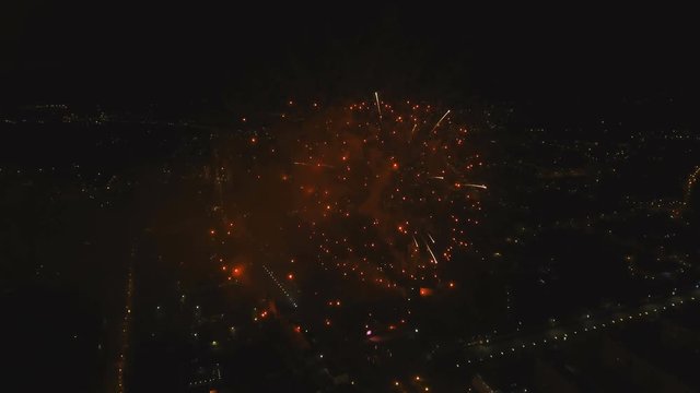 Aerial view Beautiful fireworks video from the drone in the night sky on celebration. Sparks. Fireworks are a class of explosive pyrotechnic devices used for aesthetic and entertainment purposes