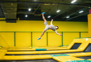 trampoline jumper performs complex acrobatic exercises and somersault on the trampoline.