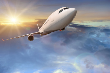 Obraz na płótnie Canvas Commercial airplane flying above clouds.