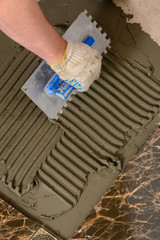 Close-up of a master's hand that makes furrows in a glutinous solution