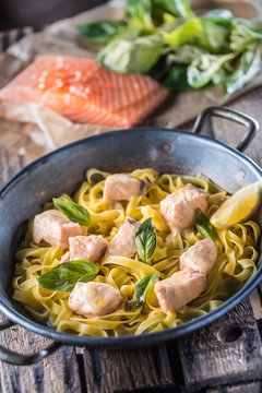 Pieces of salmon with pasta tagliatelle lemon and basil