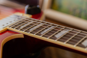 Fototapeta premium Electric guitar body and neck detail on wooden background vintage look