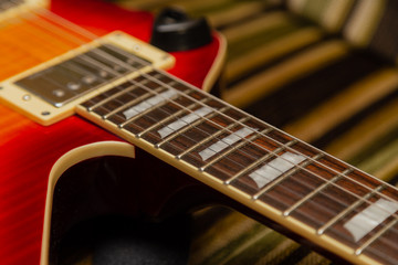 Fototapeta premium Electric guitar body and neck detail on wooden background vintage look