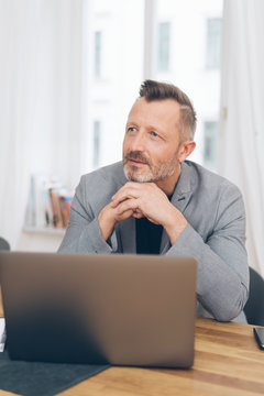 Mature man sitting in front of laptop