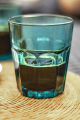 Espresso coffee on a blue transparent water glass