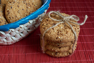 Savory cookies sprinkled with sesame seeds, sunflower on red table