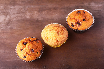 Tasty chocolate cupcakes, muffins on a white wooden table