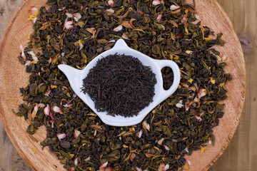 Different tea with flowers and herbs on a wooden background. Aromatherapy and health. Copy space