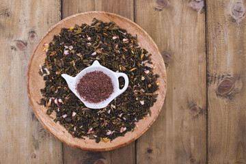 Leaves of green tea and dried flowers. Preparation of healing aromatic tea. Health.