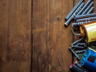 bunch of petards and firecrackers on a wooden surface close up