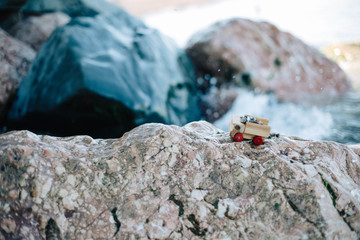Symbol of travel, adventure and dreams. Miniature wooden off road truck full of rocks