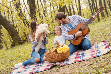 Parents enjoying picnic day with kid