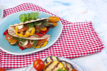 Tortilla, traditional Mexican food. Lunch with vegetables on the grill, healthy food. Place for text