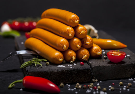 Wiener Sausages on black background.