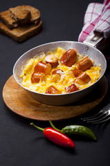Breakfast of scrambled eggs with and sausages