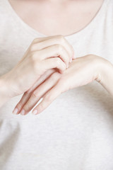 
Close up of woman scratching her hand, dermatology or allergy issues