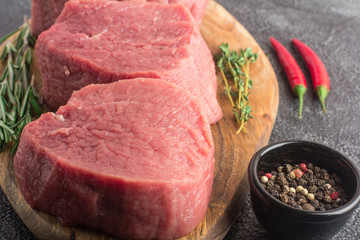 Raw beef meat on a cutting board. Close-up