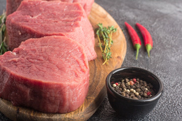 Raw beef meat on a cutting board. Close-up