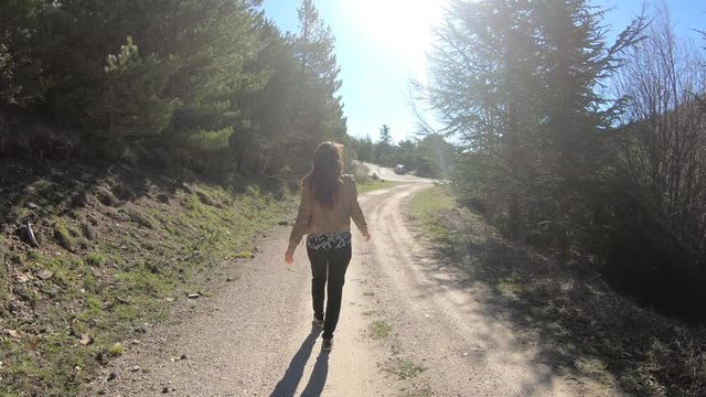young single woman walking on a path in the Pyrenees, Aude in southern France