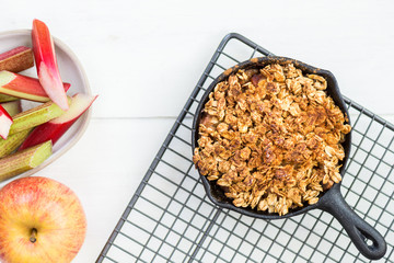 Homemade cooked rhubarb and apple crumble with oatmeal