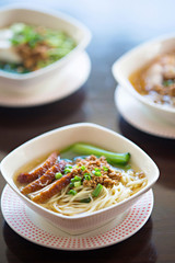 Bowls of pork noodle soup on the table