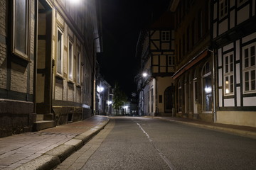 Tiny street with old nordic style houses at night in the town of Goslar, Germany in the Harz...