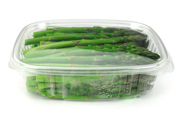 asparagus in plastic container isolated on white background 