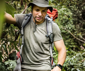 Fototapeta premium Male backpacker trekking in the forest