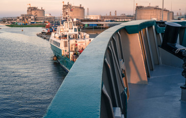 Marine vessel is morred starboard side alongside berth or quay in port. Small crew boat os moored...
