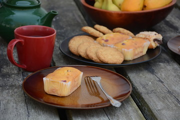 The freshly baked sweet mini loaves on rustic wooden background. Breakfast with a sweet mini loaves. The mini loaves with cranberry, poppy seed and mixed berries