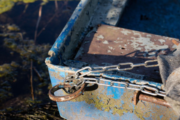 Chain for securing a fishing boat against theft. Moored fishing boat.
