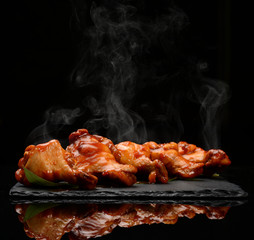 Hot and spicy bbq chicken wings with dip and hot sauce on black stone plate  - 204165087