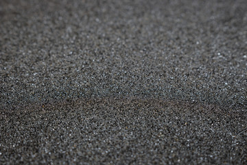 Fototapeta na wymiar Dark sandpaper for background texture