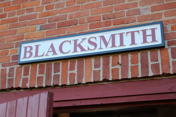 Fototapeta na wymiar Blacksmith Sign on Old Building