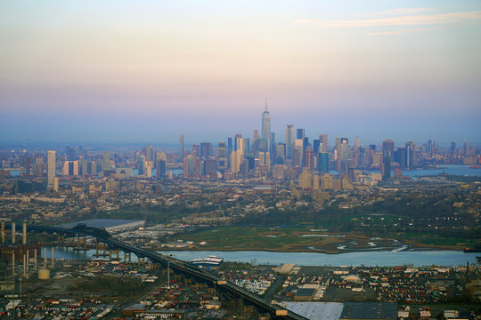Aerial view of the Manhattan skyline in New York City seen from an airplane window at sunset